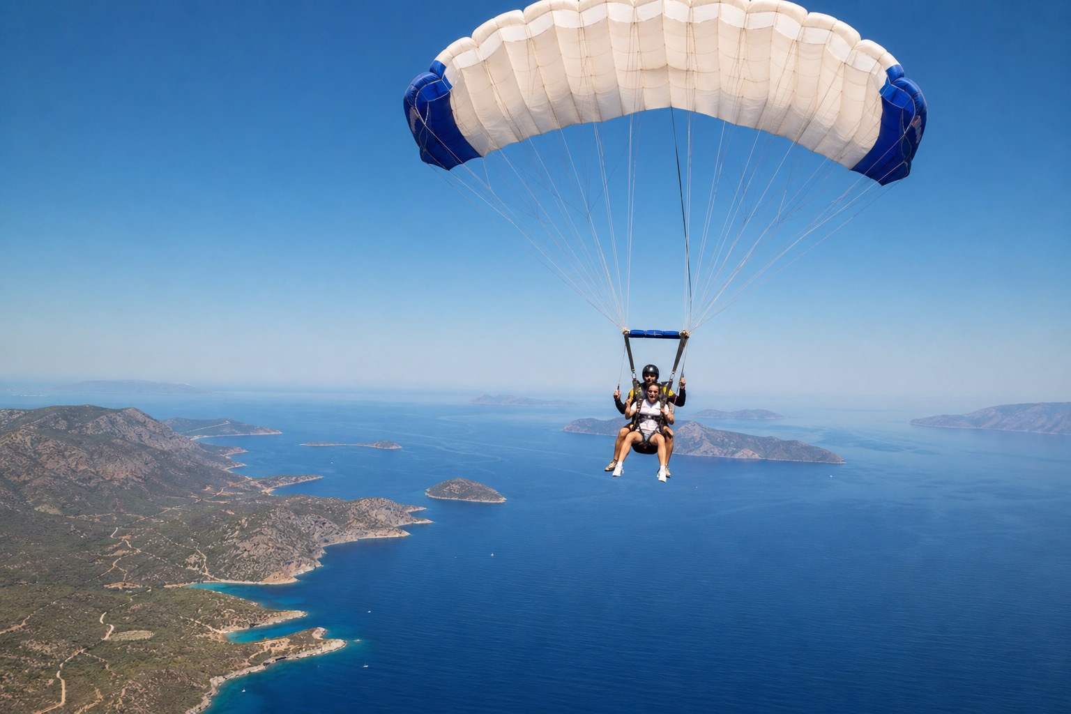 Tandem skydiving under parachute above Greek islands